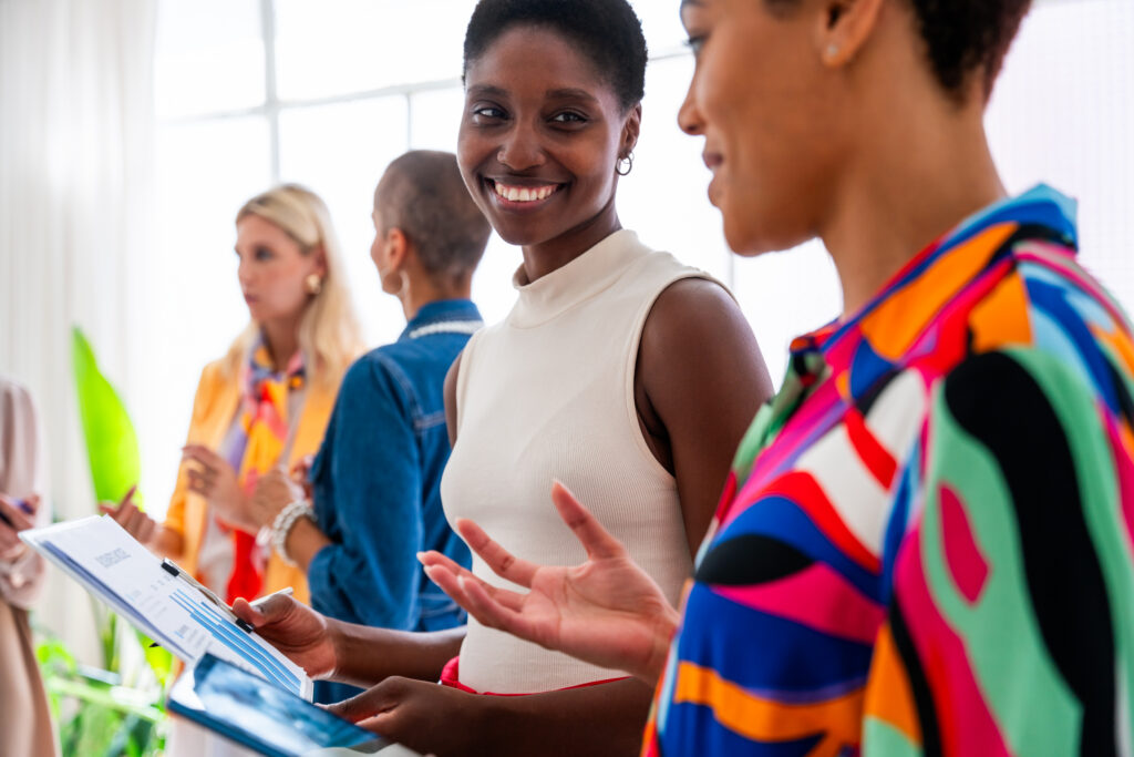 Two women discussing an in-person brand awareness strategy
